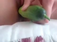 Using a cucumber, hot honey masturbates in her bedroom.